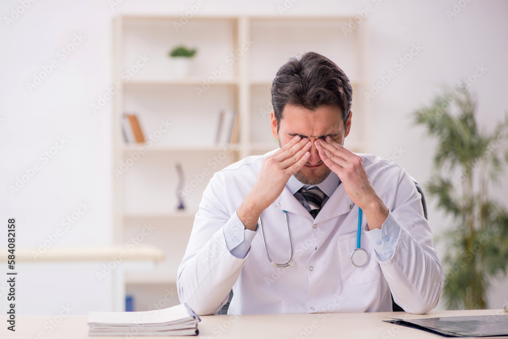 Young male doctor working in the clinic