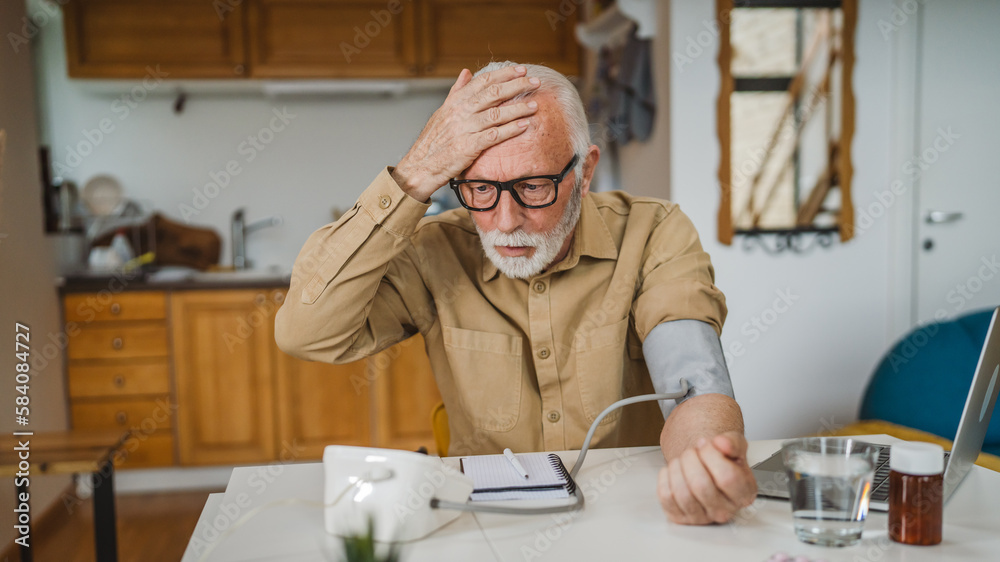 Man senior caucasian male use device to measure blood pressure at home Man senior caucasian male use device to measure blood pressure at home