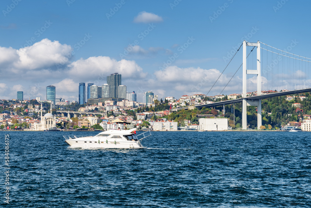 Boat crossing the Bosporus. View of the Bosphorus Bridge
