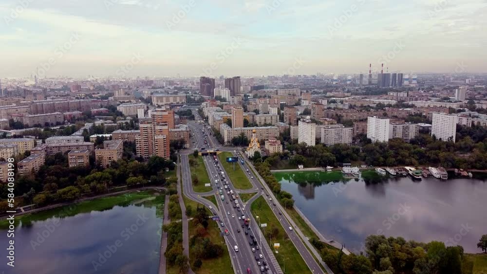 Aerial view of the traffic jam against the backdrop of the cityscape. Sleeping area near the pond. Summer Moscow landscape Aerial view of the traffic jam against the backdrop of the cityscape. Sleeping area near the pond. Summer Moscow landscape