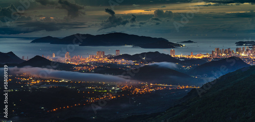 Panorama of the coastal city of Nha Trang with brilliant lights, seen from the top of a high mountain in Vinh Phuong commune, Nha Trang City, Khanh Hoa province, Vietnam
