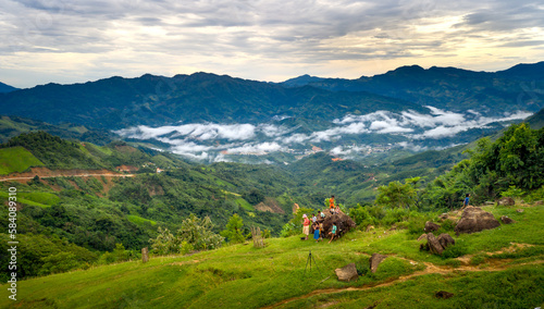 A female tourist plays with ethnic minority children in the high mountains in Nam Tra My District, Quang Nam Province, Vietnam   photo