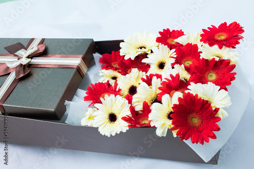 A bunch of flowers in a beautiful gift box, Barberton. daisy,rose multi-colored