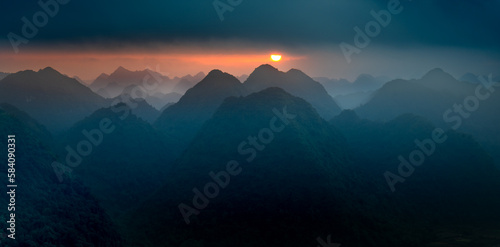 Fototapeta Naklejka Na Ścianę i Meble -  The magical scene of the mountains resemble the successive message they are covered with layers of lush green vegetation at dawn in Bac Son district Lang Son Province, Vietnam