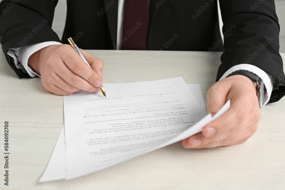 Notary signing document at wooden table, closeup Notary signing document at wooden table, closeup