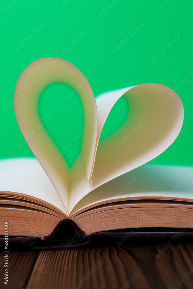 Book pages curved into heart shape Book pages curved into heart shape