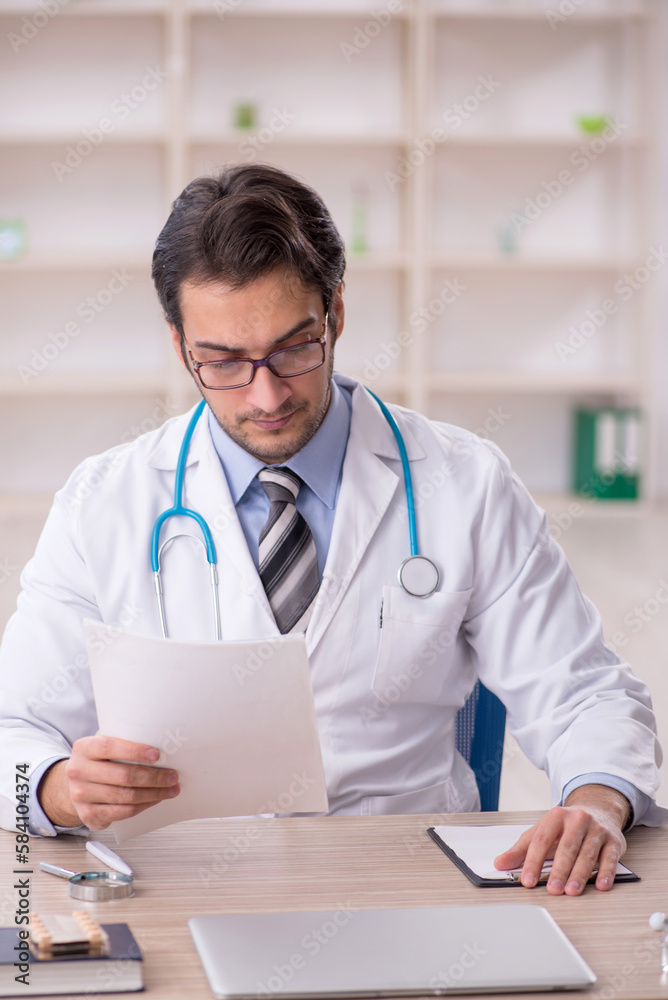Young male doctor working in the clinic