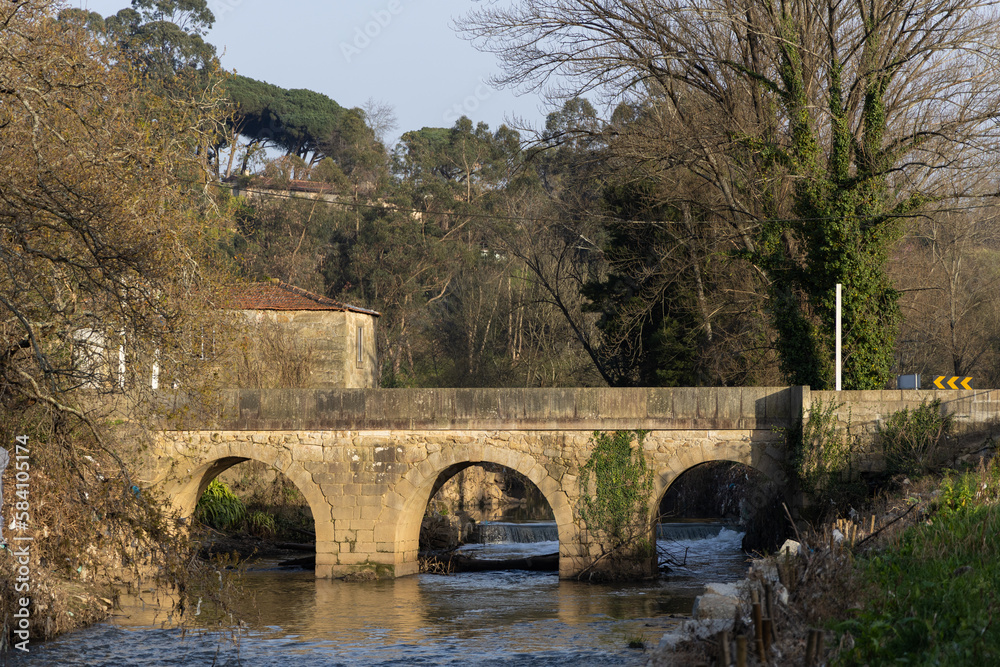 Ancient bridge made of stone over the river.