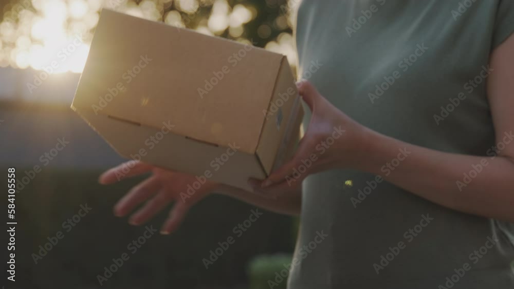 Close-up buyer hand people buy carry carton send or give postal mail to woman. Online nature shop net zero waste store by omni channel post express. Supply chain in eco friendly retail order shipment.