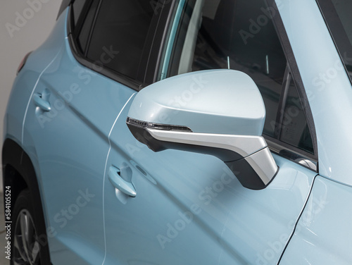  Side mirror of a blue car close-up. Exterior detail