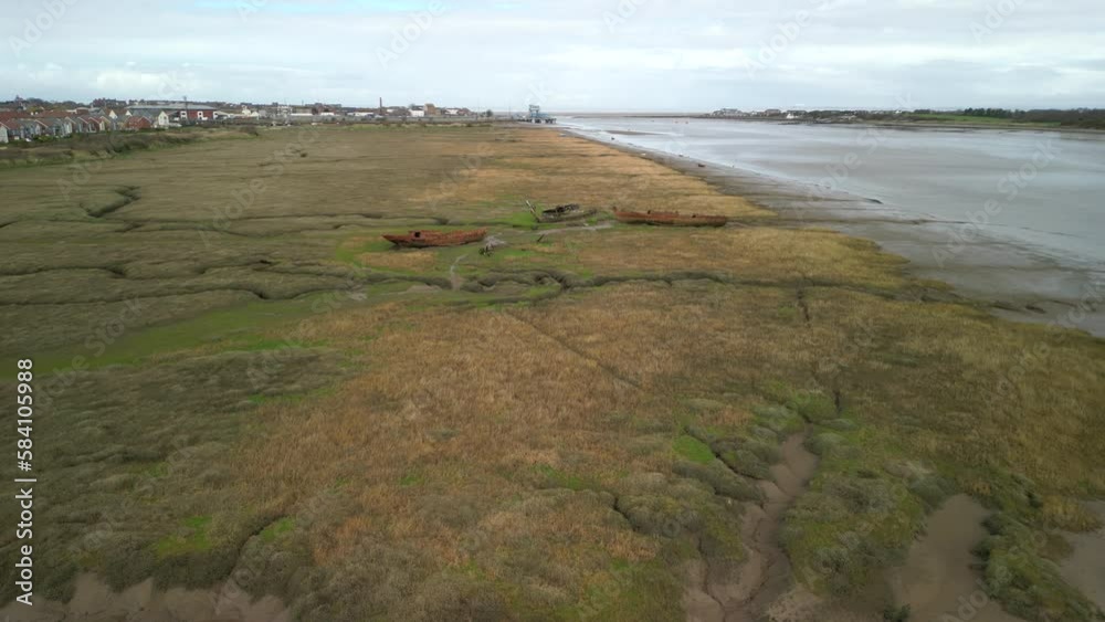 Approaching rusted shipwrecks on salt marsh next to River Wyre at Fleetwood Marshes Nature Reserve Approaching rusted shipwrecks on salt marsh next to River Wyre at Fleetwood Marshes Nature Reserve