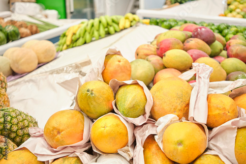 Tropical fruits for sale at a vegetable market stall  papayas  mangoes  pineapples  bananas  melons.