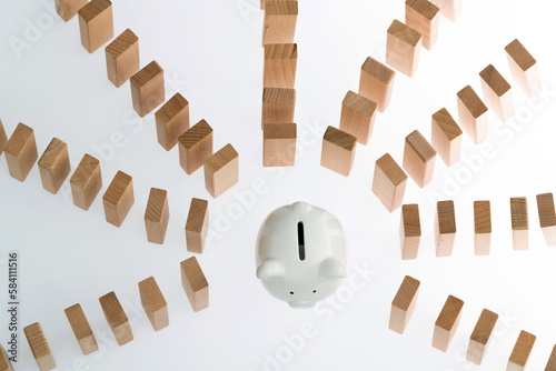 Piggy bank with dominoes on white background