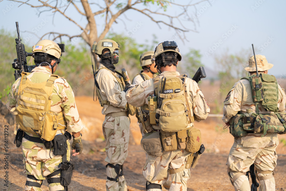 Fototapeta premium Team of U.S. Army marine corps soldier military war with gun weapon participating and preparing to attack the enemy in Thailand during exercise Cobra Gold training in battle. Combat force.