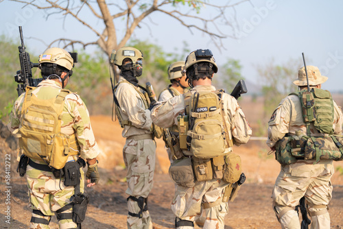 Team of U.S. Army marine corps soldier military war with gun weapon participating and preparing to attack the enemy in Thailand during exercise Cobra Gold training in battle. Combat force.