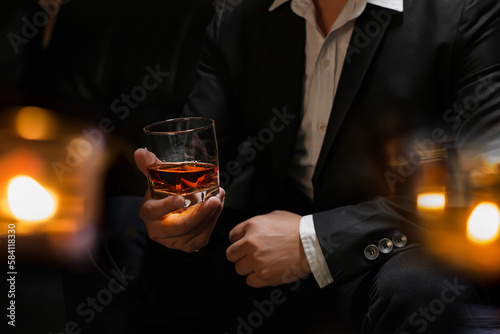businessmen holding a glass of whiskey