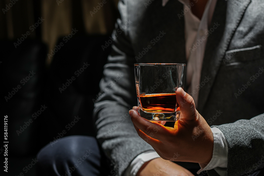 Closeup businessmen holding a glass of whiskey