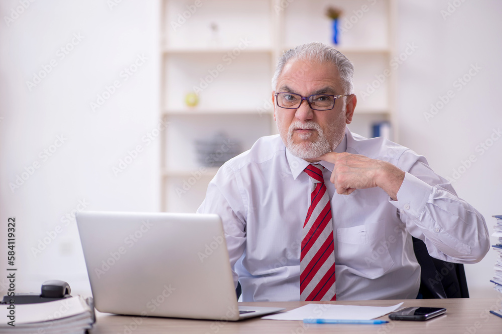 Old male employee and too much work in the office Old male employee and too much work in the office