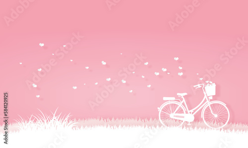 bicycle in the meadow or garden with origami hearts in basket. valentine and paper art in pink and white background.