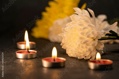 Lit candles and beautiful chrysanthemums