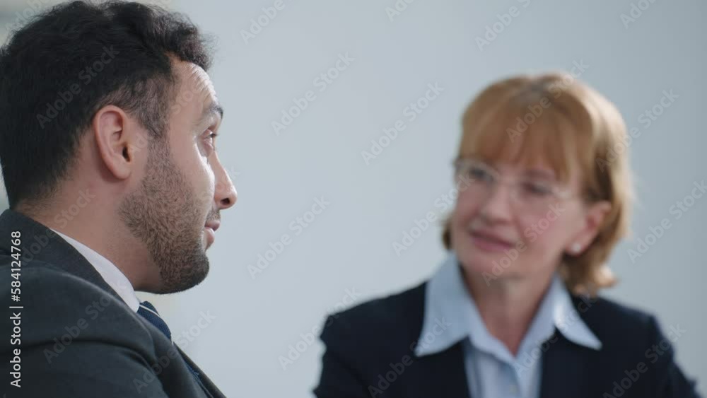Indian businessman and businesswoman manager talking and brainstorm using laptop shares sales growth of company in meeting room at modern office Indian businessman and businesswoman manager talking and brainstorm using laptop shares sales growth of company in meeting room at modern office