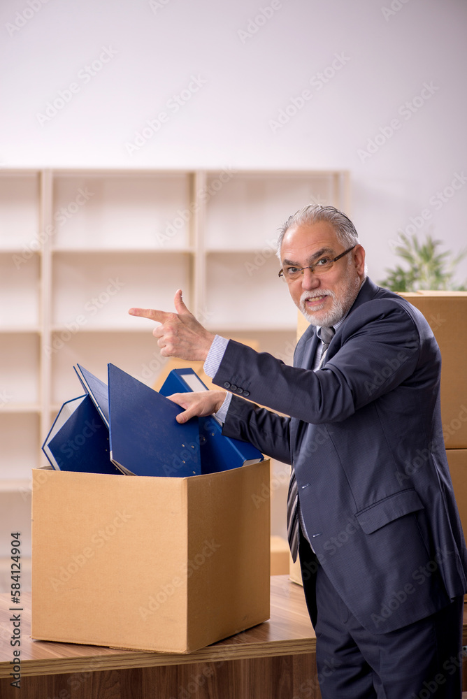 Old male employee in office relocation concept