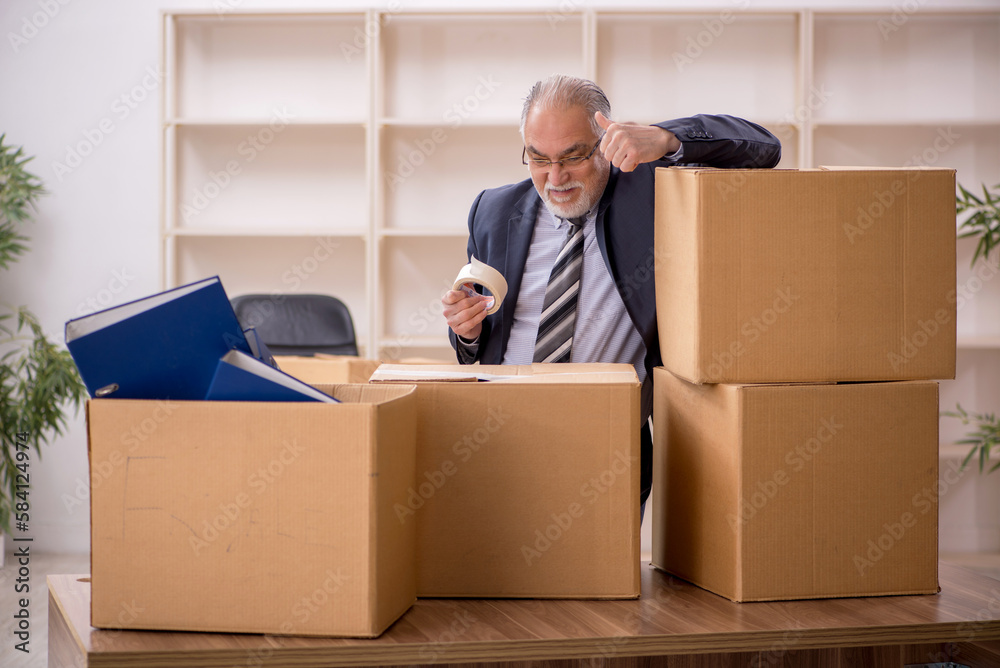Old male employee in office relocation concept Old male employee in office relocation concept