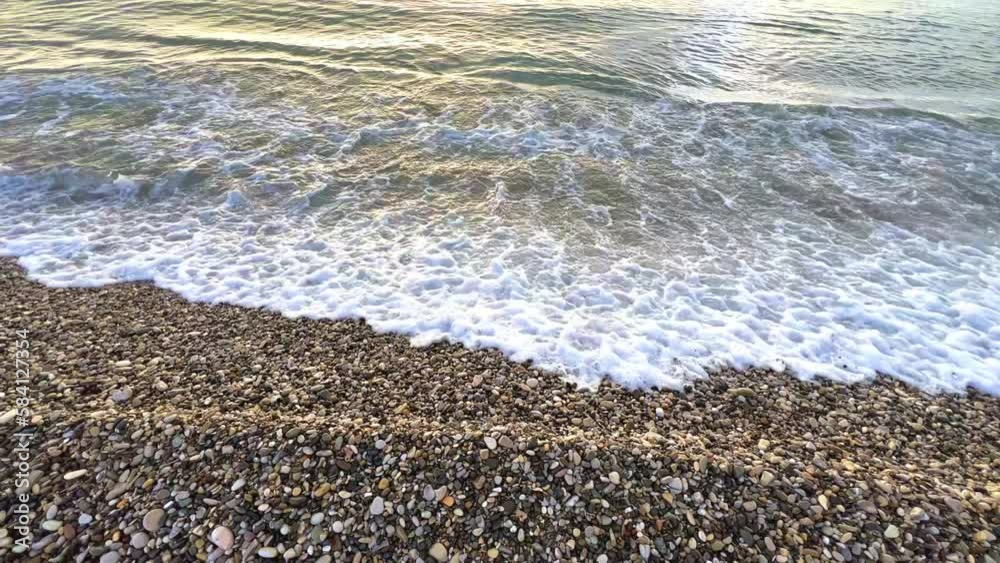 Powerful sea waves are crashing on the Black Sea coast. Waves splash on the beach with pebbles during a storm. Storm at sea. Panoramic view of the Black Sea. Russia. Sunset on the beach. 4K Powerful sea waves are crashing on the Black Sea coast. Waves splash on the beach with pebbles during a storm. Storm at sea. Panoramic view of the Black Sea. Russia. Sunset on the beach. 4K
