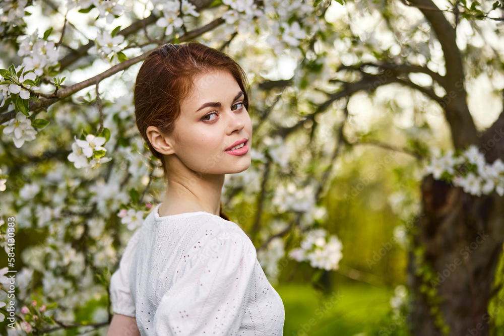 beautiful woman standing near blossoming bush beautiful woman standing near blossoming bush