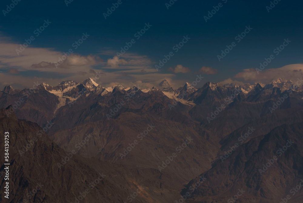 landscape of snow mountains with blue sky and white clouds, karakorum range with k2 and other high mountains in the gilgit baltistan 