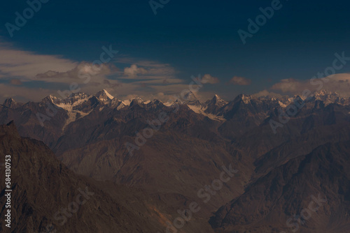 landscape of snow mountains with blue sky and white clouds, karakorum range with k2 and other high mountains in the gilgit baltistan 