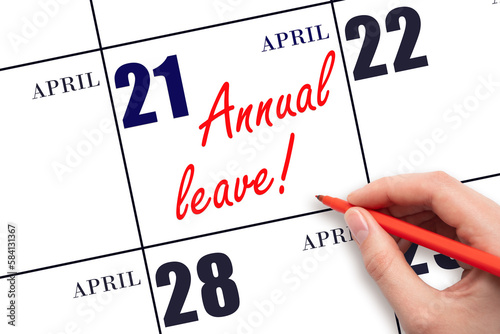 Hand writing the text ANNUAL LEAVE and drawing the sun on the calendar date April 21