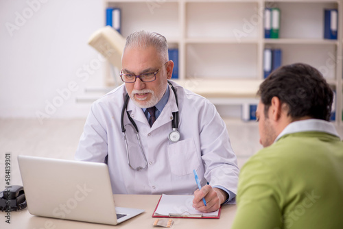 Young male patient visiting old male doctor