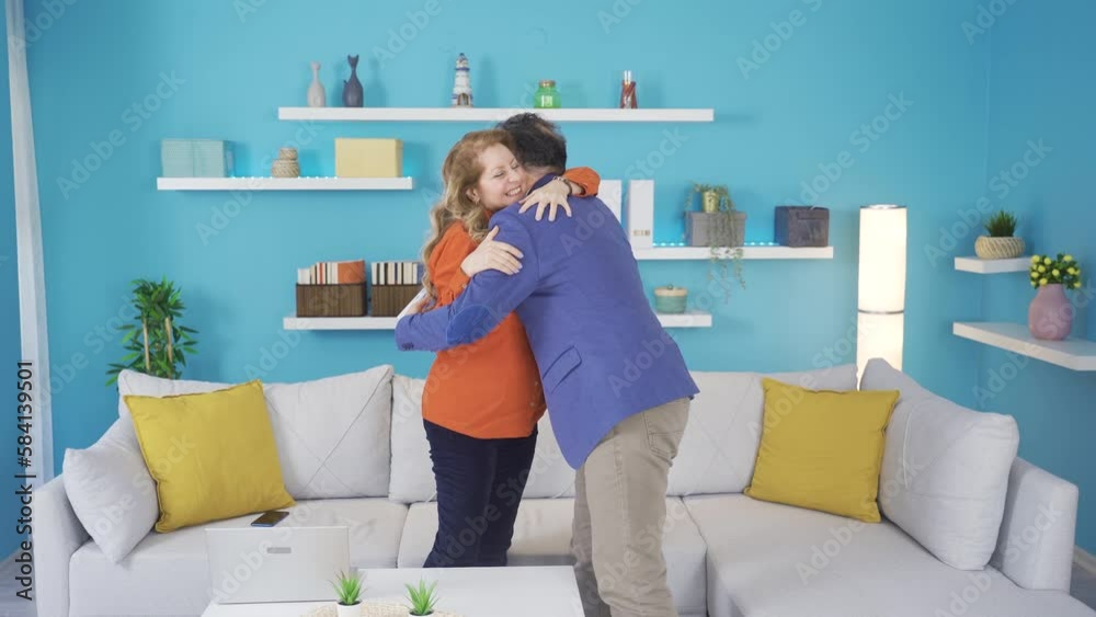 The man who comes home from work happily hugs his wife and they sit and chat.
The businessman comes home with his file and is happy. His wife greets him and they chat.
The man who comes home from work happily hugs his wife and they sit and chat.
The businessman comes home with his file and is happy. His wife greets him and they chat.