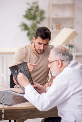 Young male patient visiting old male doctor radiologist