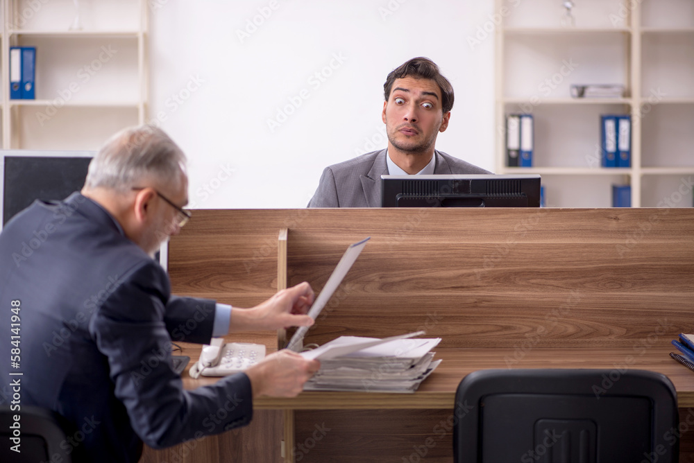 Two male colleagues working in the office Two male colleagues working in the office