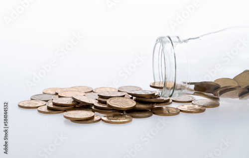 Coins spilling from glass jar