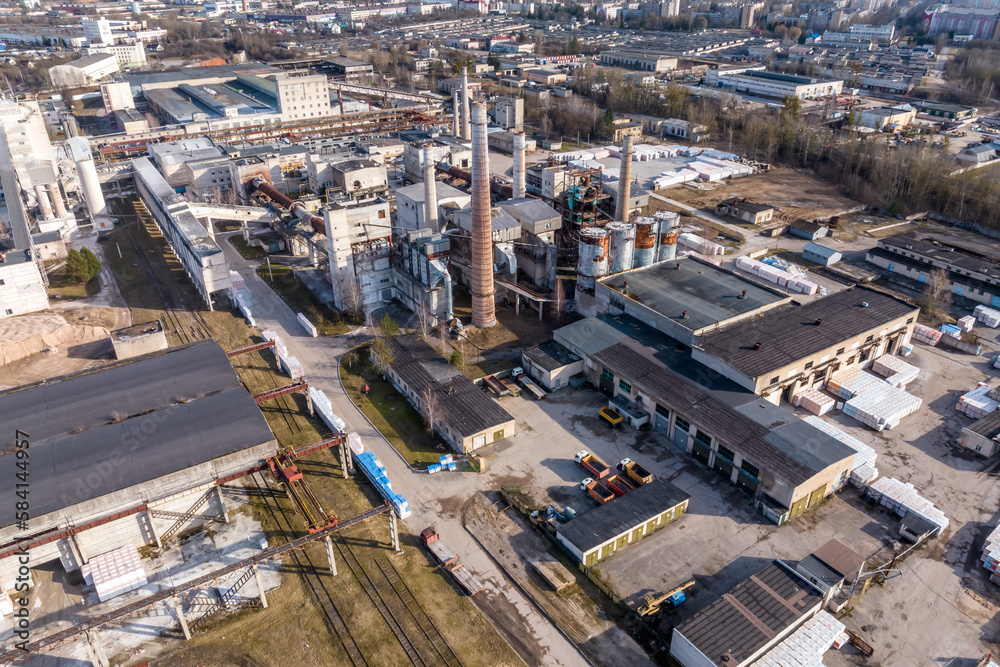Fototapeta premium aerial panoramic view of pipes as of an old abandoned factory