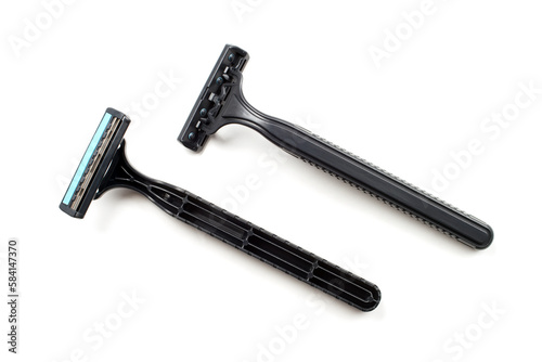 Two disposable plastic razors on a white background. Black disposable razors.