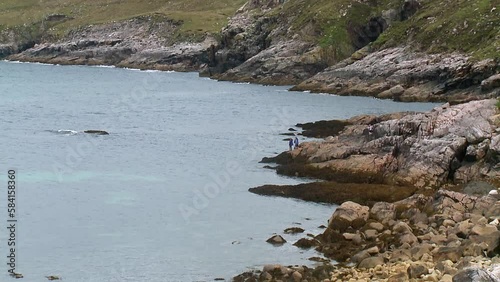 A shot of a family fishing off the cliffs around Hushinish on the Isle of Harris. Filmed on the Outer Hebrides of Scotland. photo