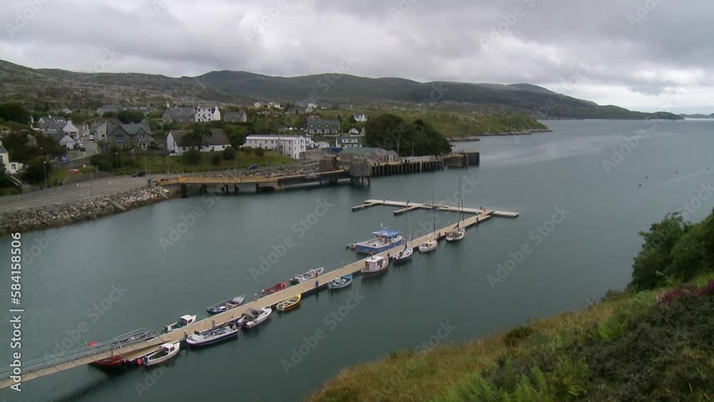 A shot of the village of Tarbert with the pontoon dock in the foreground. Filmed on the Isle of Harris, part of the Outer Hebrides of Scotland. A shot of the village of Tarbert with the pontoon dock in the foreground. Filmed on the Isle of Harris, part of the Outer Hebrides of Scotland.