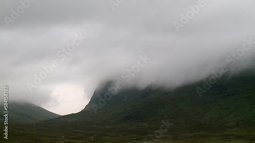 A time lapse of the mist and fog rolling through a mountain range near the village of Tarbert on the Isle of Harris, part of the Outer Hebrides of Scotland. photo