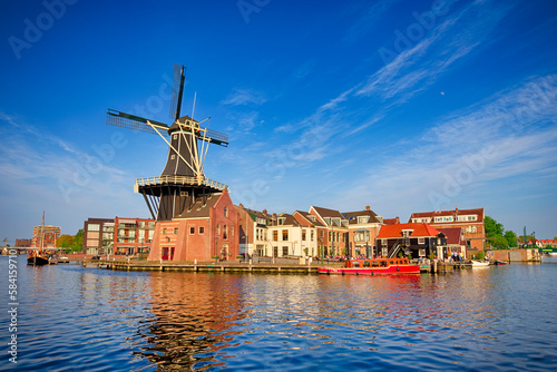 Picturesque View of Harlem Sight With De Adriaan Windmill on Spaarne River On The Background At Noon.