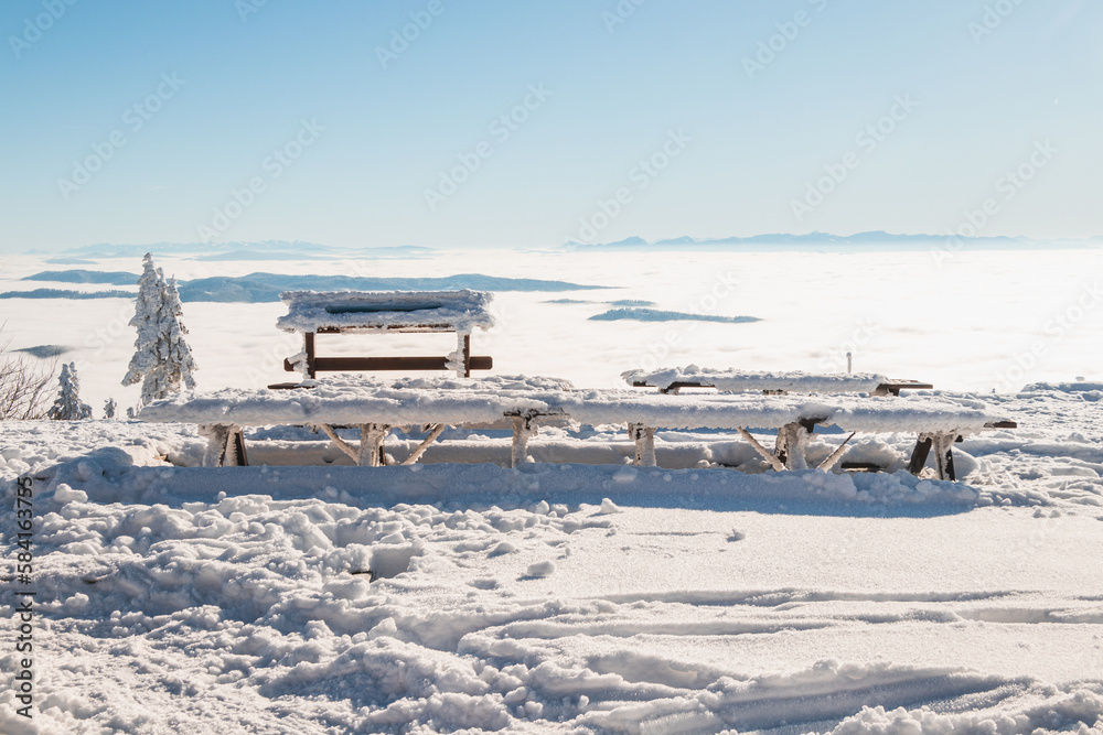 Ideal place with benches and wooden tables at the top of Lysa Hora for breakfast at sunrise and catching vitamin D. Czech Republic, Europe