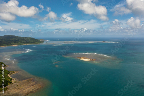 Sandy island in the blue sea. Crocodile island. Santa Ana, Cagayan. Philippines.