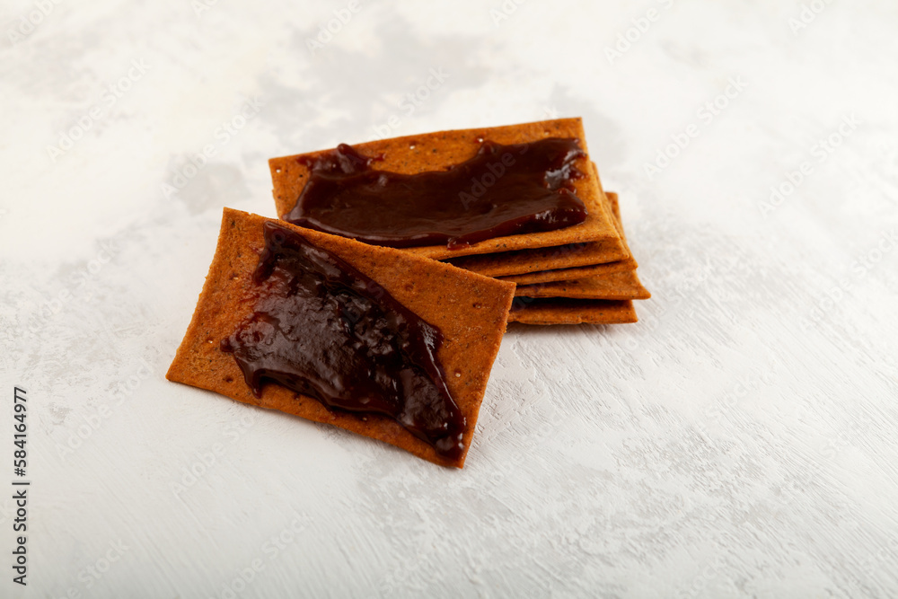 Rye crisps with thick Australian spread made from leftover brewers