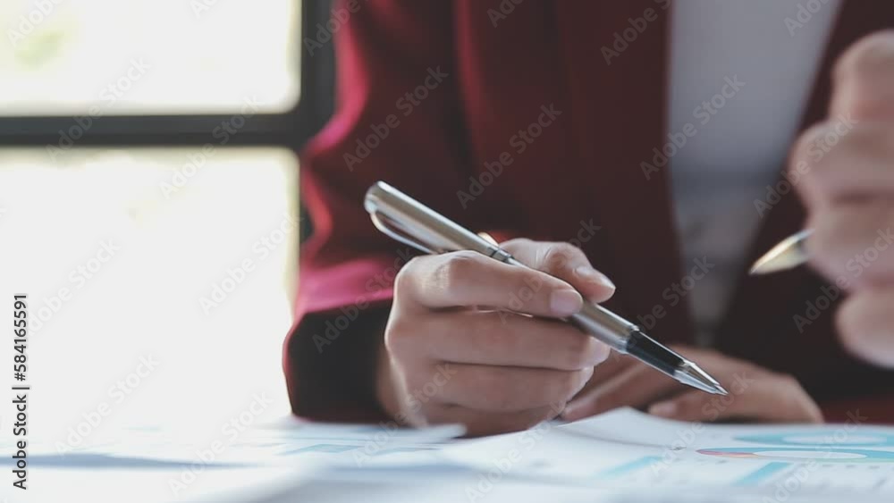 Financial analysts analyze business financial reports on a digital tablet planning investment project during a discussion at a meeting of corporate showing the results of their successful teamwork.