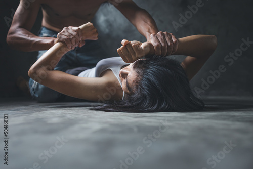 Close up of man hands holding a woman hands for rape and sexual abuse concept, Wound domestic violence rape, sexual assault, stop violence against women, human trafficking.