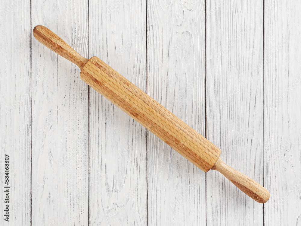 Rolling pin on white wooden background