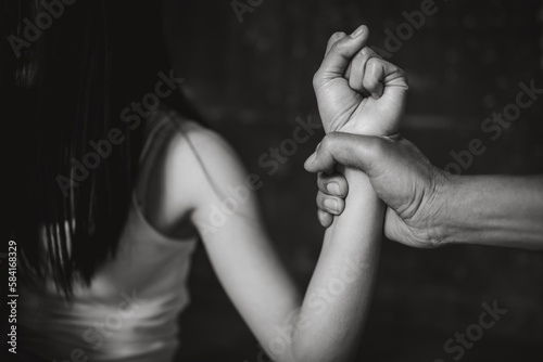 Men are violently assaulting their women, Husband beating and smothering wife during argument, Woman victim of domestic violence and abuse, Domestic violence concept.
